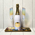 A Golden Toast champagne gift set with bubbly, gold-rimmed flutes and truffles